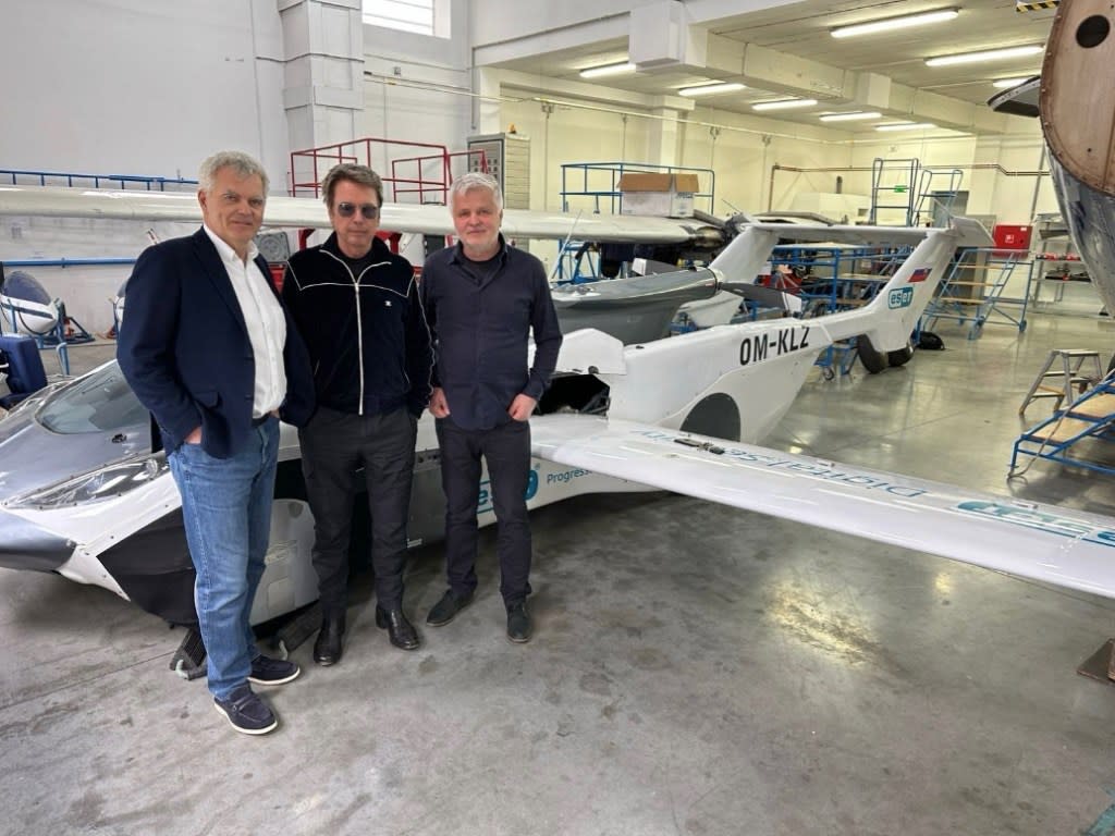 Jean-Michel Jarre [center] became the first passenger to ride in a flying car, Kleinvision announced Tuesday. Klein
