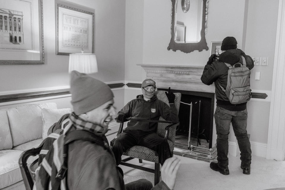 Young pro-Trump rioters sit in a meeting room inside the Capitol after breaking in.<span class="copyright">Christopher Lee for TIME</span>