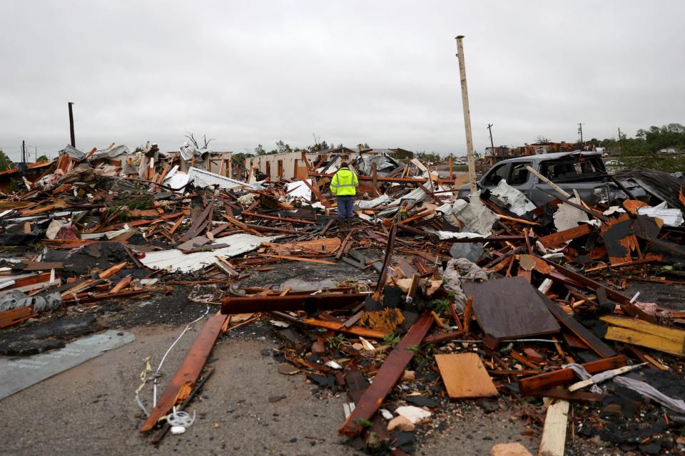 A man is surrounded by tornado damage after severe storms moved through the night before in Sulphur, Okla., Sunday, April 28, 2024. (Bryan Terry/The Oklahoman via AP)