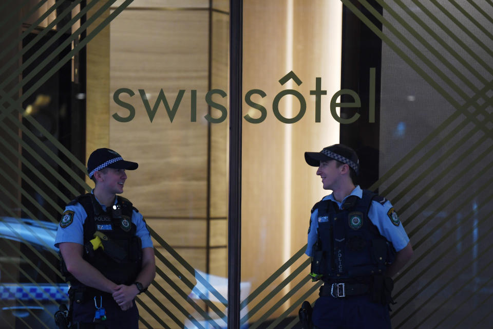 NSW Police stand guard outside the Swissotel Hotel in Market Street, Sydney, Thursday, March 26, 2020. The hotel has been declared  a "human health response zone", believed to be holding Australian passengers from the Norwegian Jewel cruiseliner. Source: AAP