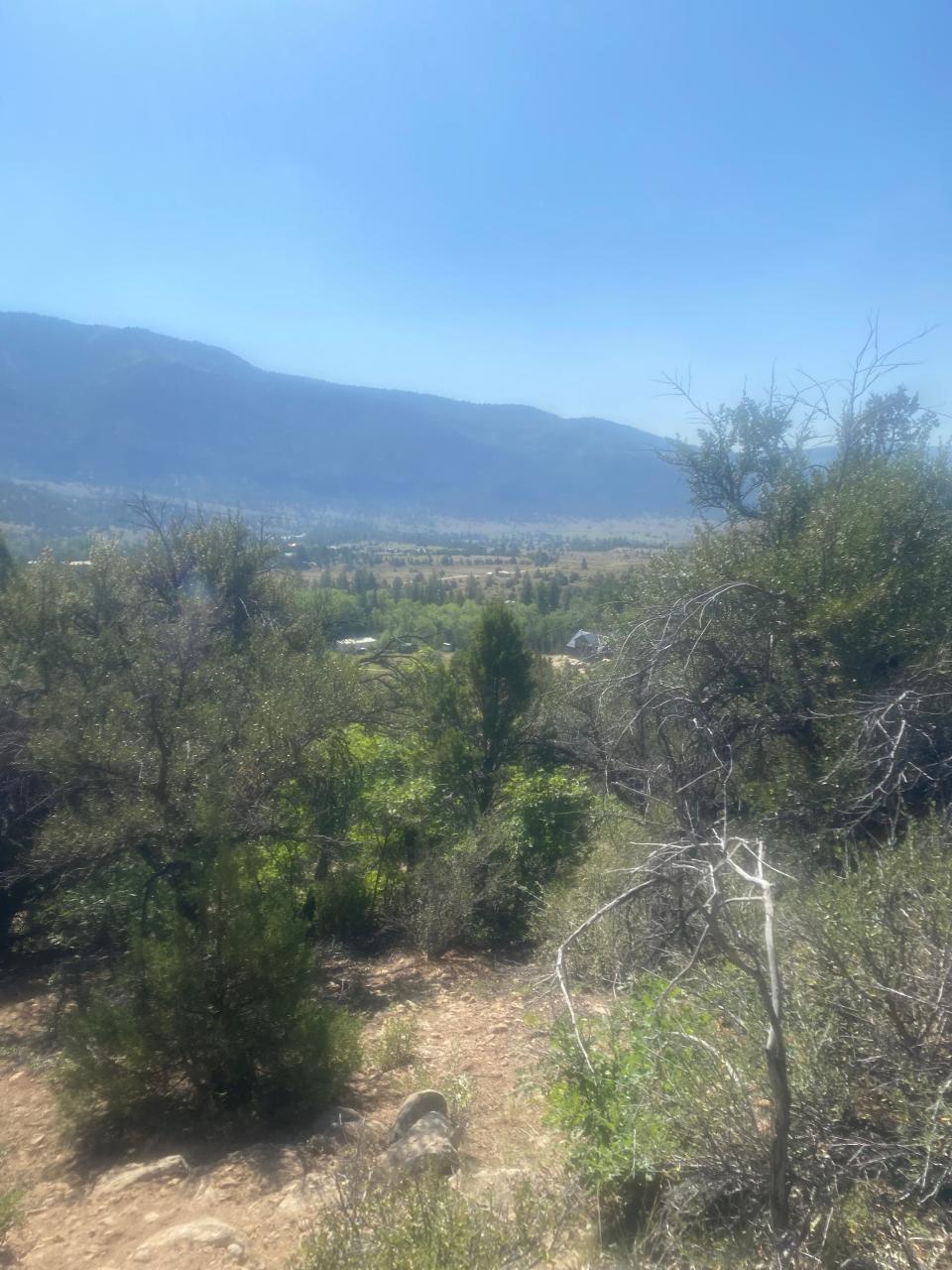 The view looks northwest, toward where the woman was found on the slope below the cliffs.