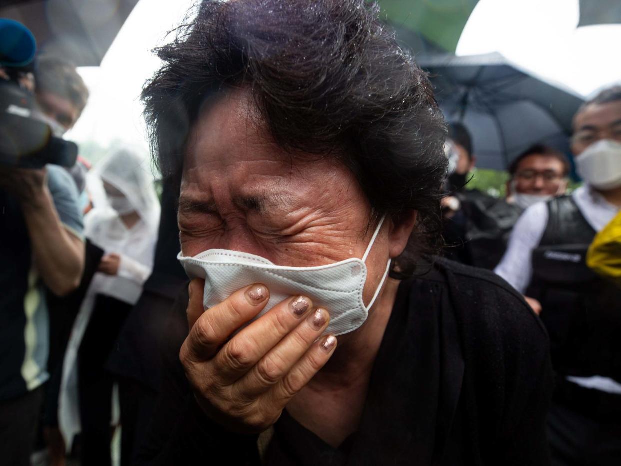 A mourner weeps during the funeral ceremony for late Seoul mayor Park Won-soon, outside Seoul City Hall in Seoul, South Korea, 13 July 2020: Jeon Heon-Kyun/EPA