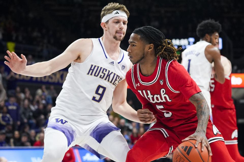 Utah guard Deivon Smith, right, is defended by Washington guard Paul Mulcahy during the first half of an NCAA college basketball game Saturday, Jan. 27, 2024, in Seattle. | Lindsey Wasson, Associated Press