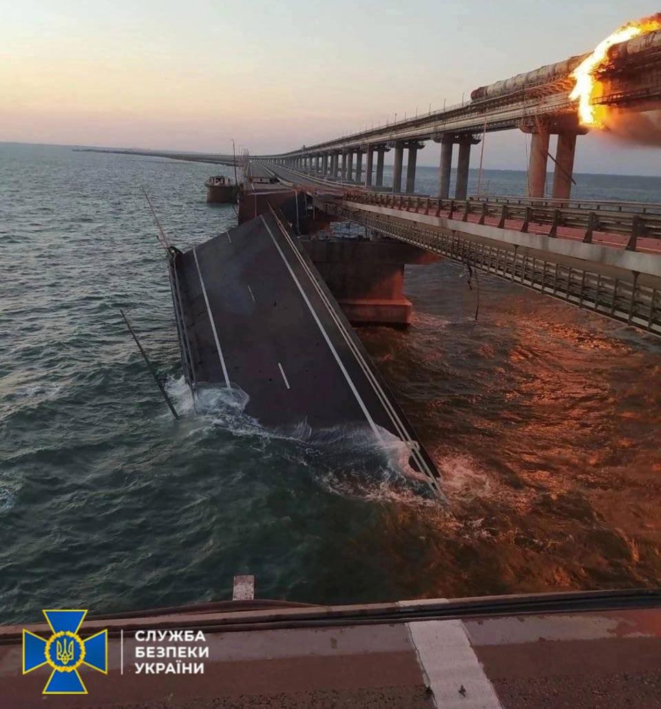 Editorial use only. HANDOUT /NO SALES Mandatory Credit: Photo by UKRAINE SECURITY SERVICE HANDOUT/EPA-EFE/Shutterstock (13448165a) A handout photo made available by the Ukraine Security Service (SSU) shows a collapsed part of the Kerch Strait bridge in Crimea, 08 October 2022. According to Russian authorities, "an explosion was set off at a cargo vehicle on the motorway part of the Crimean bridge on the side of the Taman peninsula, which set fire to seven fuel tanks of a train that was en route to the Crimean peninsula. Two motorway sections of the bridge partially collapsed." Parts of Crimea bridge collapse follwing fire, Kerch Strait, Ukraine - 08 Oct 2022