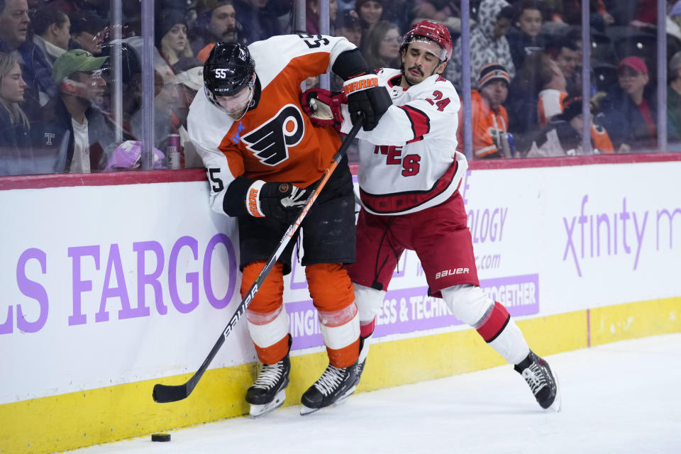 Philadelphia Flyers' Rasmus Ristolainen, left, tries to keep the puck away from Carolina Hurricanes' Seth Jarvis during the third period of an NHL hockey game, Tuesday, Nov. 28, 2023, in Philadelphia. (AP Photo/Matt Slocum)