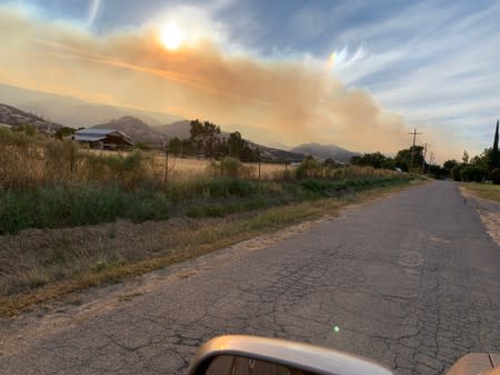 Smoke from the Sand Fire is seen in the sky in the Capay Valley in California