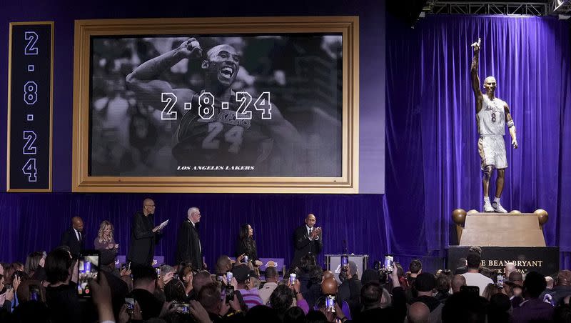 Attendees view a statue of former Los Angeles Lakers guard Kobe Bryant after its unveiling outside the NBA basketball team’s arena, Thursday, Feb. 8, 2024, in Los Angeles. 