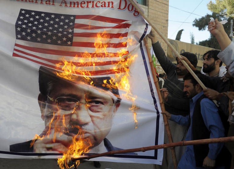 Supporters of Khilji Qaumi Ittehad burn a poster of Pakistan's former military ruler Pervez Musharraf during a protest in Quetta on March 24, 2013. Musharraf is being protected around the clock by a bevvy of retired army commandos and intelligence agents, along with army and police guards