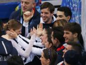 Carolina Kostner of Italy is greeted by her teammates in the "kiss and cry" area during the Team Ladies Short Program at the Sochi 2014 Winter Olympics, February 8, 2014. REUTERS/David Gray (RUSSIA - Tags: SPORT FIGURE SKATING SPORT OLYMPICS)