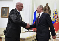 Russian President Vladimir Putin, right, greets FIFA President Gianni Infantino, during a meeting in the Kremlin in Moscow, Russia, Wednesday, Feb. 20, 2019. (Yuri Kadobnov/Pool Photo via AP)