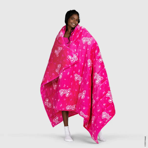 Model wrapped in Barbie™ weighted blanket