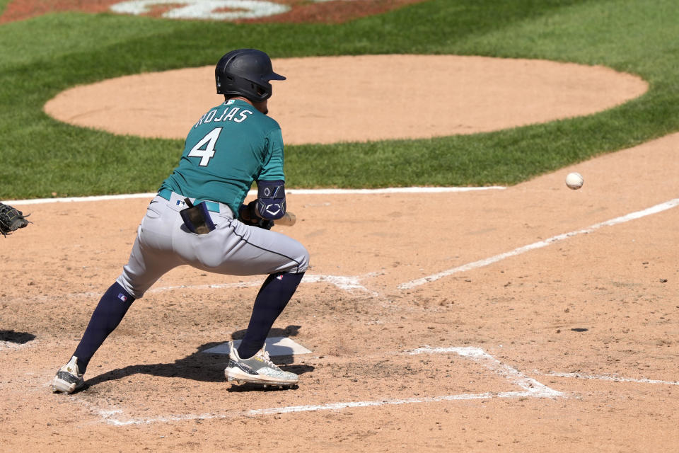 Seattle Mariners' Josh Rojas lays down an RBI bunt single off a pitch from Chicago White Sox relief pitcher Aaron Bummer during then seventh inning of a baseball game Wednesday, Aug. 23, 2023, in Chicago. (AP Photo/Charles Rex Arbogast)