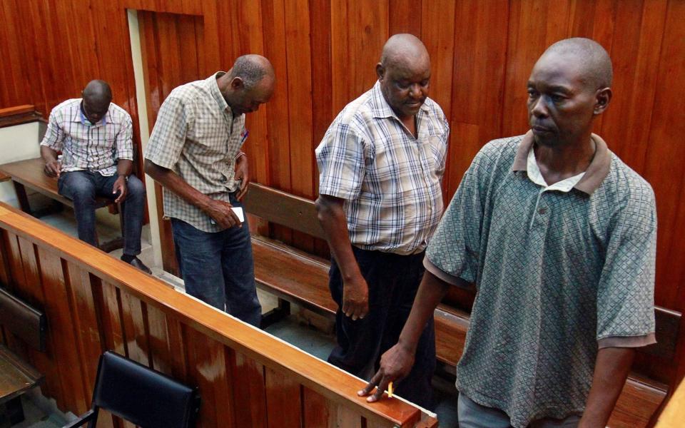 Kenyan police officers accused of the killing Alexander Monson, a British citizen who was found dead in his prison cell in 2012, are brought in to the dock during the first day of the their trial at the high court in Mombasa, Kenya January 22, 2019. REUTERS/Joseph Okanga - Reuters