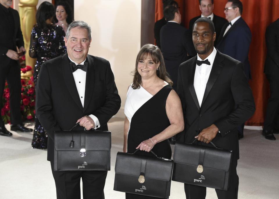 Representatives from PricewaterhouseCoopers LLP arrive at the Oscars on Sunday, March 12, 2023, at the Dolby Theatre in Los Angeles. (Photo by Richard Shotwell/Invision/AP)