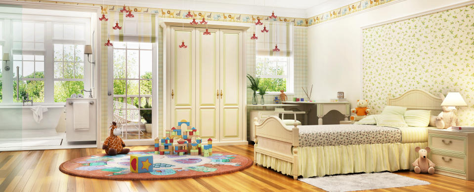 Spacious, well-decorated child's bedroom with a bed, desk, wardrobe, plush toys, and a play area with blocks and a giraffe. There's an adjacent bathroom and large windows