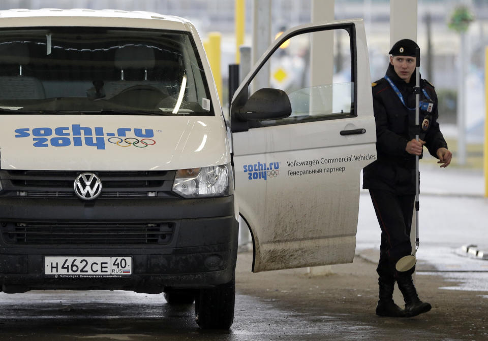 A Russian police officer searches a vehicle at an entrance to the Sochi 2014 Olympic Winter Games park, Thursday, Jan. 23, 2014, in Sochi, Russia. The Olympics begin on Feb. 7. (AP Photo/David J. Phillip)