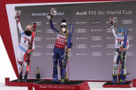 From left, second placed Switzerland's Michelle Gisin, first placed Italy's Marta Bassino and third placed Slovenia's Meta Hrovat celebrate on the podium of a women's World Cup giant slalom, in Kranjska Gora, Slovenia, Sunday, Jan. 17, 2021. (AP Photo/Giovanni Auletta)