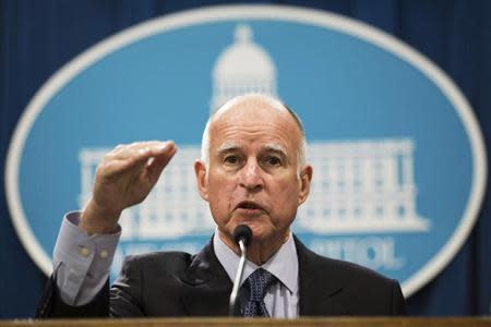 California Governor Jerry Brown gestures as he unveils his proposed 2014-15 state budget in Sacramento, California, January 9, 2014. REUTERS/Max Whittaker