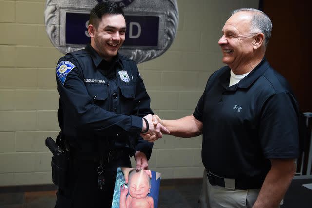 <p>Ashley O'Chap/South Bend Police Department </p> From left: Matthew Hegedus-Stewart holding his baby picture with Gene Eyster.