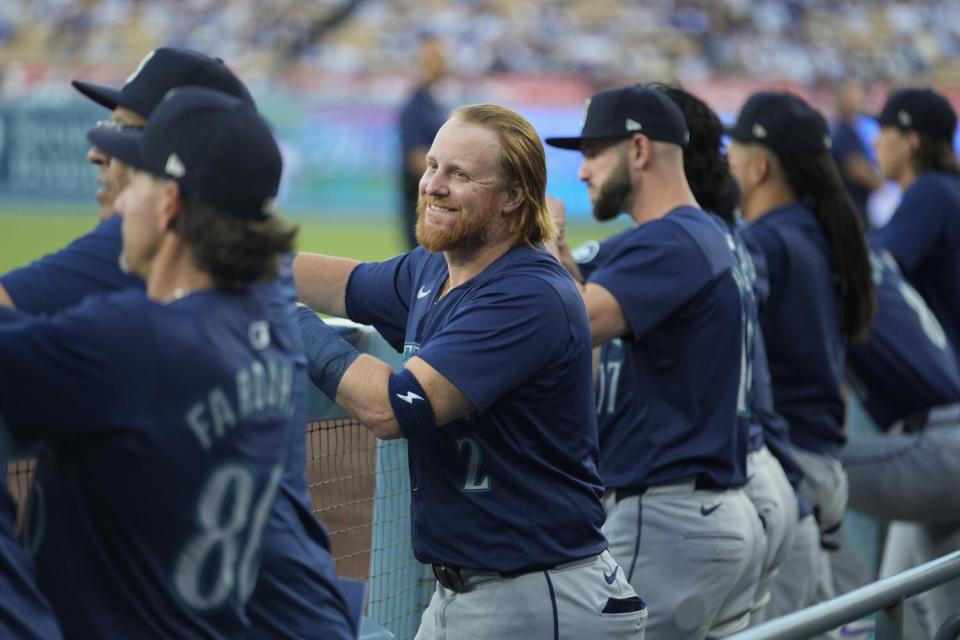 Seattle's Justin Turner smiles in the dugout before Monday's game against the Dodgers.