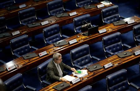 Senator Antonio Anastasia, rapporteur of the special senate committee checks Brazil's Federal Constitution before the debate for the voting of the impeachment of President Dilma Rousseff in Brasilia, Brazil, May 11, 2016. REUTERS/Ueslei Marcelino