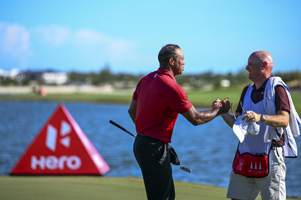 NASSAU, BAHAMAS - DECEMBER 03: Tiger Woods shakes hands his caddie for the week, Rob McNamara, during the final round of the Hero World Challenge at Albany Golf Course on December 3, 2023 in Naussau, New Providence, Bahamas. (Photo by Tracy Wilcox/PGA TOUR via Getty Images)
