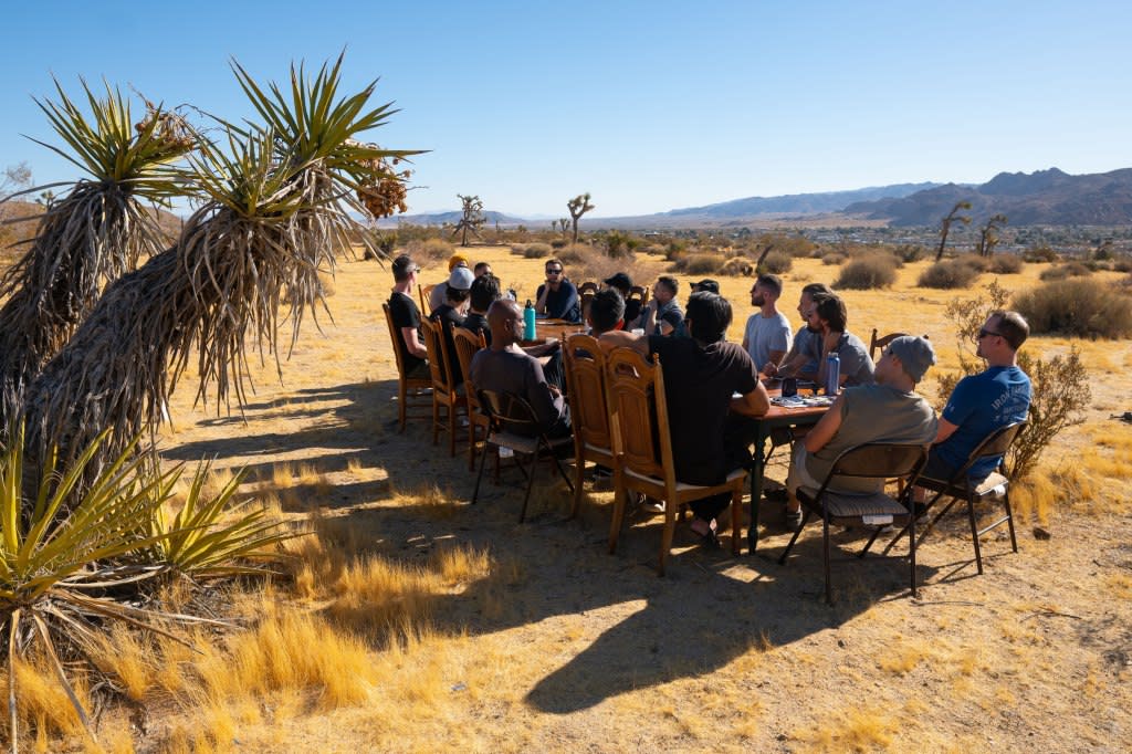 A group of men during Junto's retreat in Joshua Tree answer the prompt, “What is one of the proudest moments of your life?” during a meal.