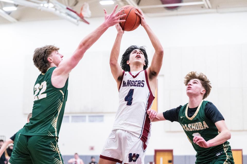 Westborough senior Nicholas Bellofatto rises through two Nashoba defenders during the game at Westborough High, Jan. 19, 2024.