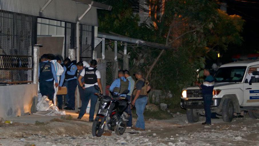 La policía y personal forense inspeccionan el billar donde 13 personas fueron asesinadas el sábado.