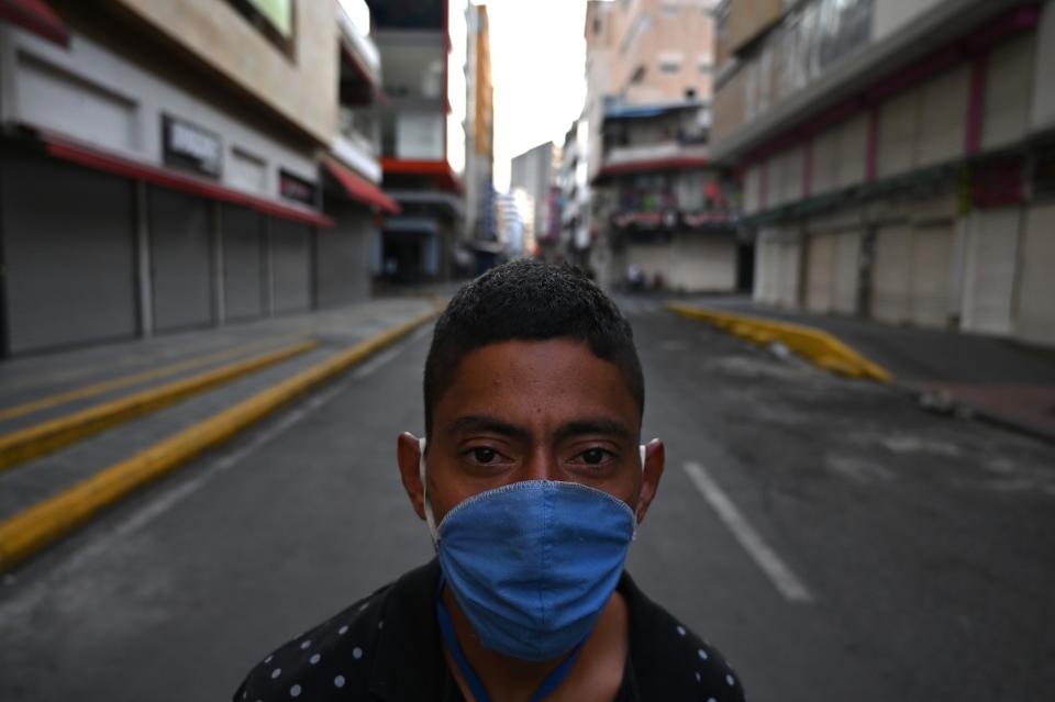 A man wears a face mask as a preventive measure against the spread of the new coronavirus, COVID-19 on March 26, 2020 in Cali, Colombia. - Colombian President Ivan Duque announced mandatory preventive isolation from March 24 to April 13 as a measure against the spread of COVID-19. (Photo by Luis ROBAYO / AFP) (Photo by LUIS ROBAYO/AFP via Getty Images) ORIG FILE ID: AFP_1Q78FJ