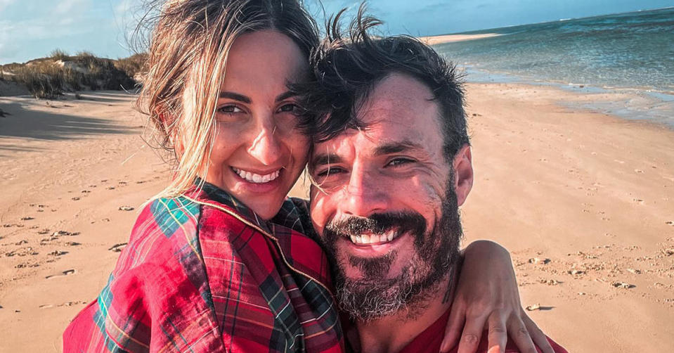 Bachelor stars Locky Gilbert and Irena Srbinovska hug on the beach