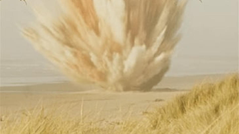 A big explosion on a sandy beach