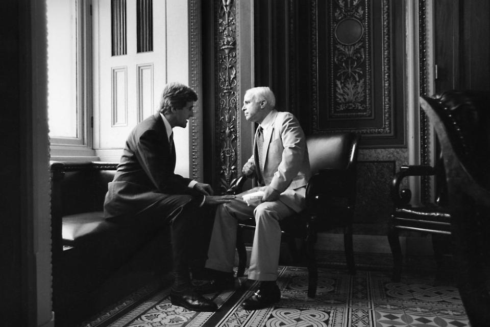 Sen. John Kerry chats with Sen. John McCain in Washington in 1997.