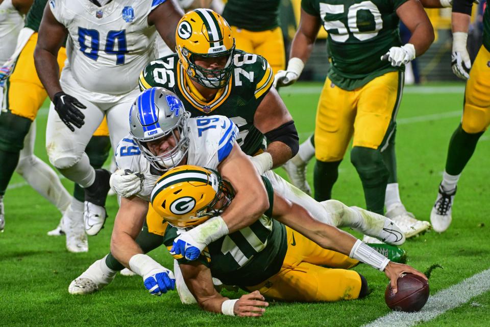 Detroit Lions defensive end John Cominsky (79) tackles Green Bay Packers quarterback Jordan Love (10) short of the goal line on a twopoint conversion attempt.