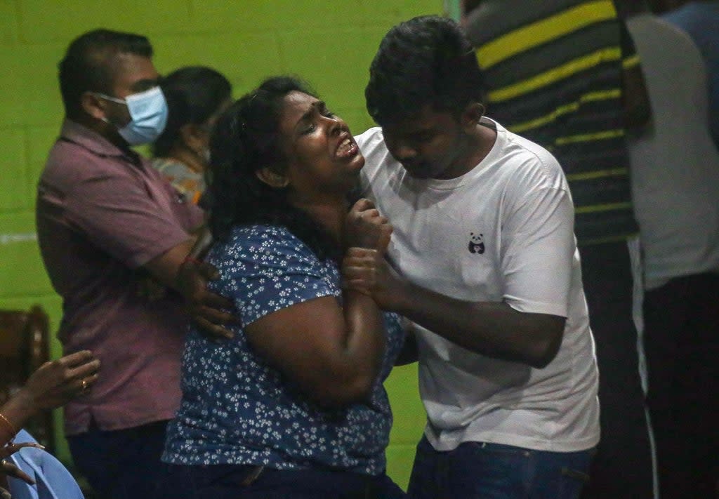 A family member reacts as the coffin carrying the body of Malaysian national Nagaenthran Dharmalingam arrives in Tanjung Rambutan in Malaysia's Perak (AFP via Getty Images)