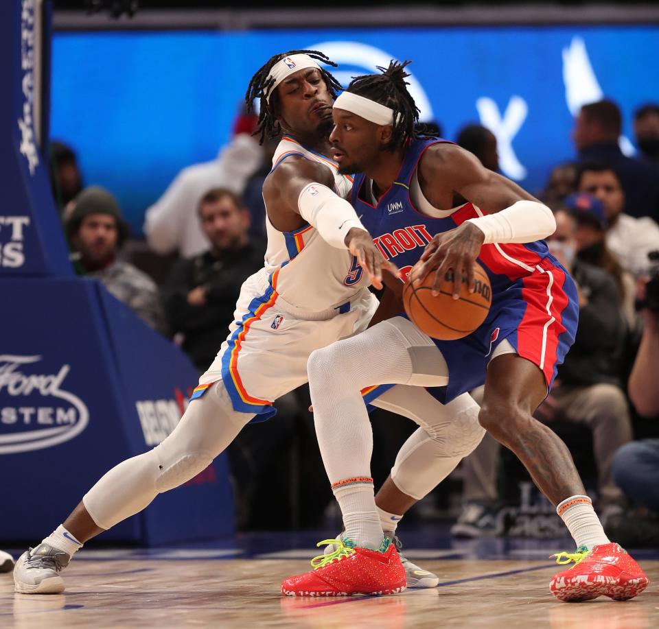 Pistons forward Jerami Grant drives against Thunder forward Luguentz Dort during the fourth period the Pistons' 114-103 loss to the Thunder on Monday, Dec. 6, 2021, at Little Caesars Arena.