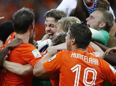 Goalkeeper Tim Krul (C) of the Netherlands celebrates with team mates after winning their penalty shootout in their 2014 World Cup quarter-finals at the Fonte Nova arena in Salvador July 5, 2014. REUTERS/Marcos Brindicci