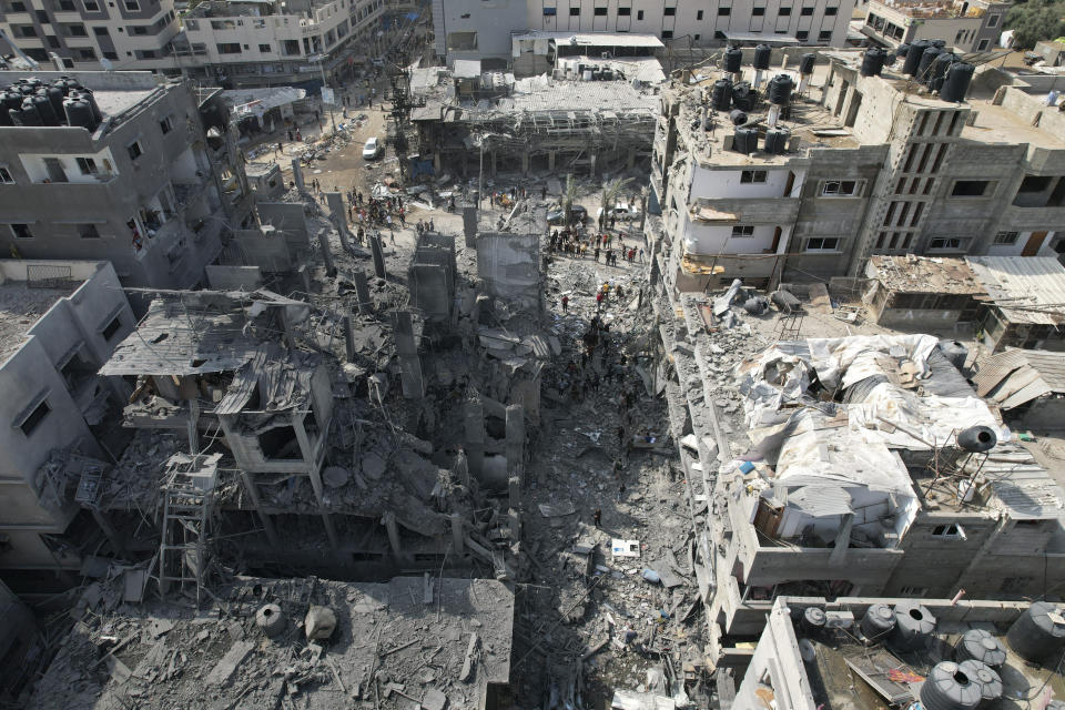 FILE - Palestinians look for survivors after the Israeli bombardment of the Gaza Strip in Deir Al-Balah on Oct. 22, 2023. U.N. humanitarian monitors say at least 2,700 people, including 1,500 children, are missing and believed buried under the rubble. (AP Photo/Hatem Moussa, File)