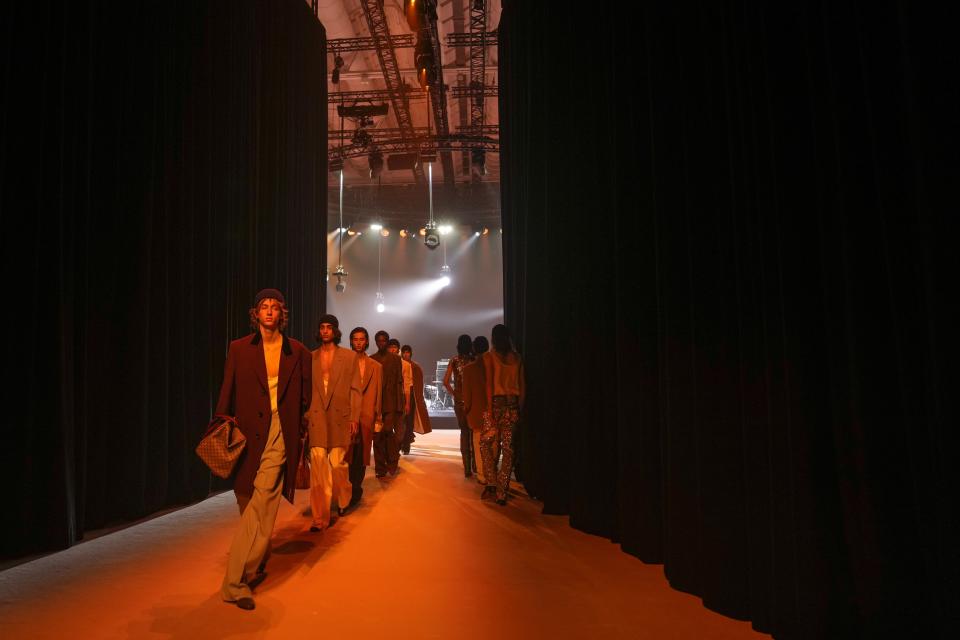 Models wear creations as part of the Gucci menswear Fall-Winter 2023-24 collection presented in Milan, Italy, Friday, Jan. 13, 2023. (AP Photo/Antonio Calanni)