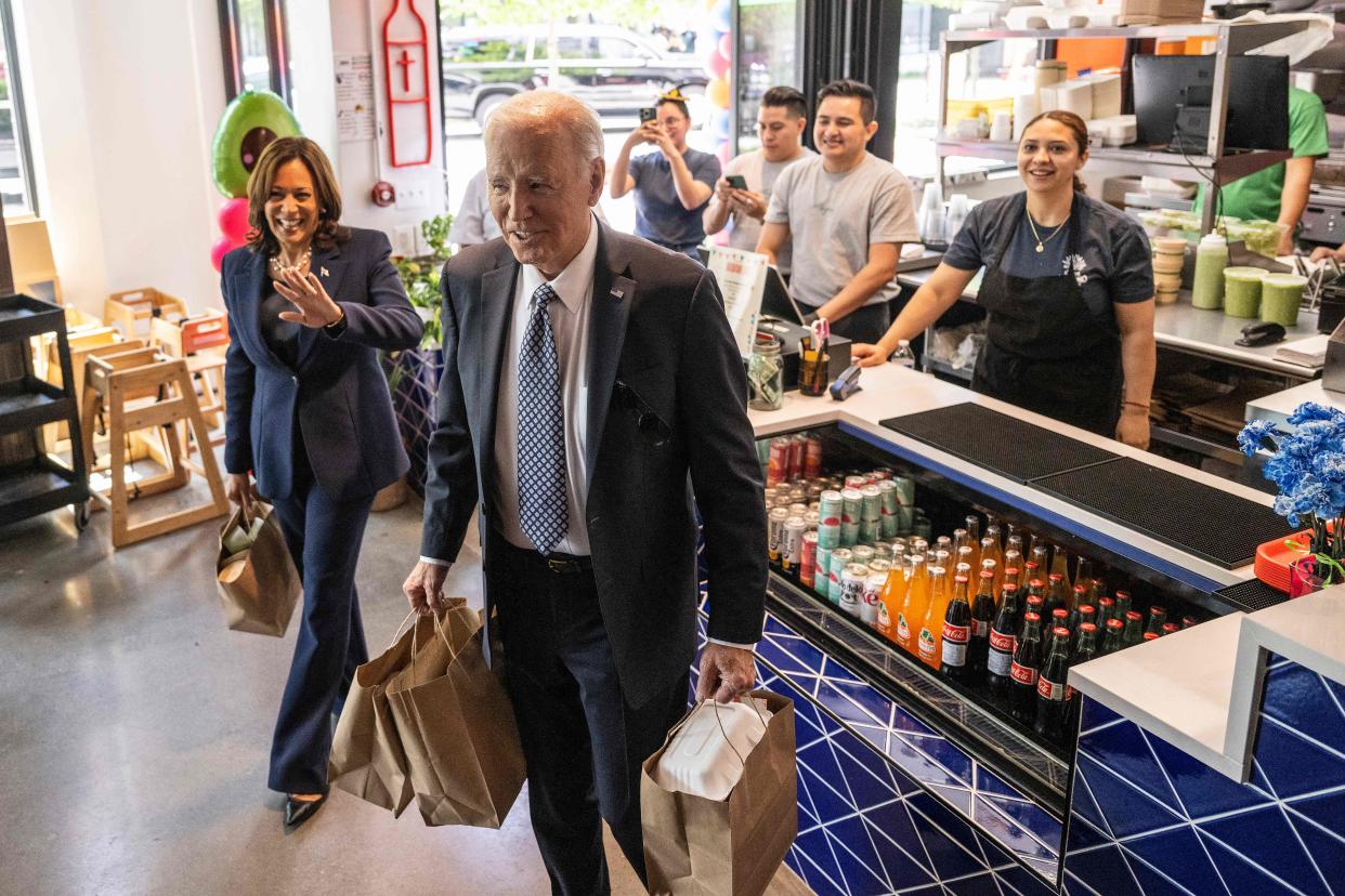 President Joe Biden carries away take-out food from Taqueria Habaneros with Vice President Kamala Harris in Washington, DC, on May 5, 2023.