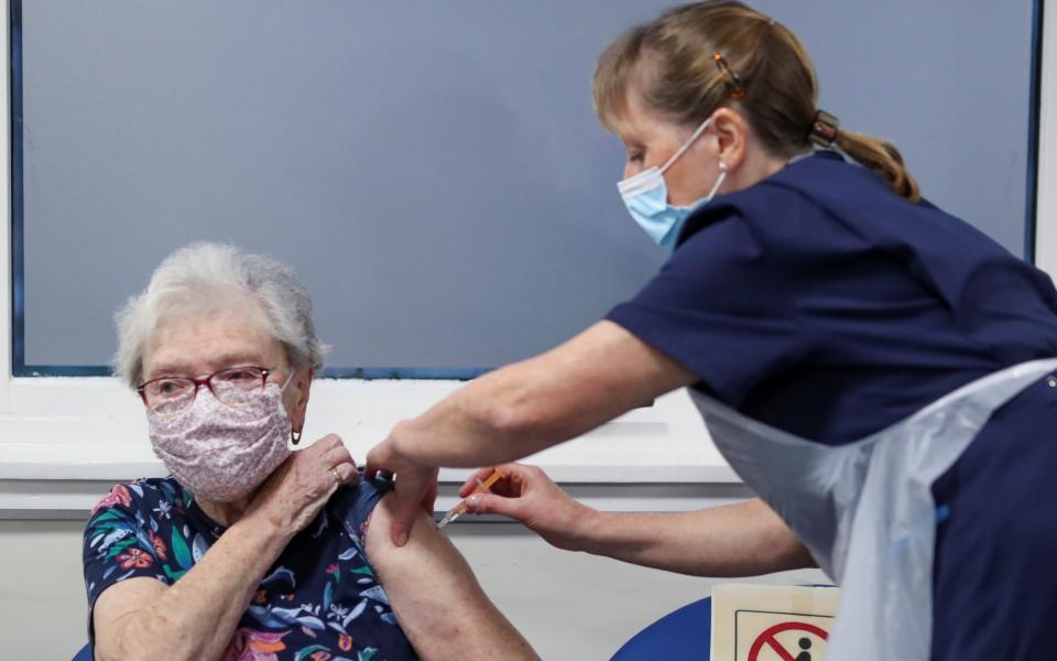 Lucy Airs receives the Oxford vaccine from Ruth Davies - Russell Cheyne/Reuters