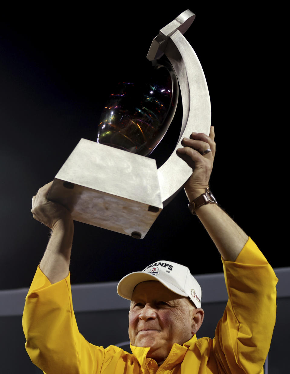 Wyoming coach Craig Bohl holds the trophy after the team's win over Toledo in the Arizona Bowl NCAA college football game Saturday, Dec. 30, 2023, in Tucson, Ariz. (Kelly Presnell/Arizona Daily Star via AP)