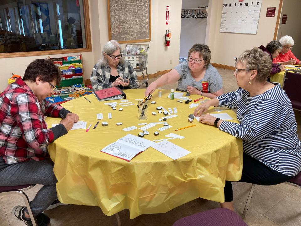 Nu Alpha Gamma Chapter members decorate kindness rocks at their May 6 chapter meeting.