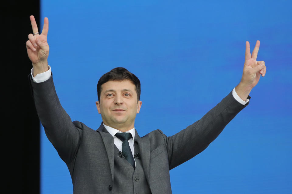 Ukrainian presidential candidate and popular comedian Volodymyr Zelenskiy makes the victory sign during the debate with Ukrainian President Petro Poroshenko at the Olympic stadium in Kiev, Ukraine, Friday, April 19, 2019. Friday is the last official day of election canvassing in Ukraine as all presidential candidates and their campaigns will be barred from campaigning on Saturday, the day before the vote. (AP Photo/Vadim Ghirda)