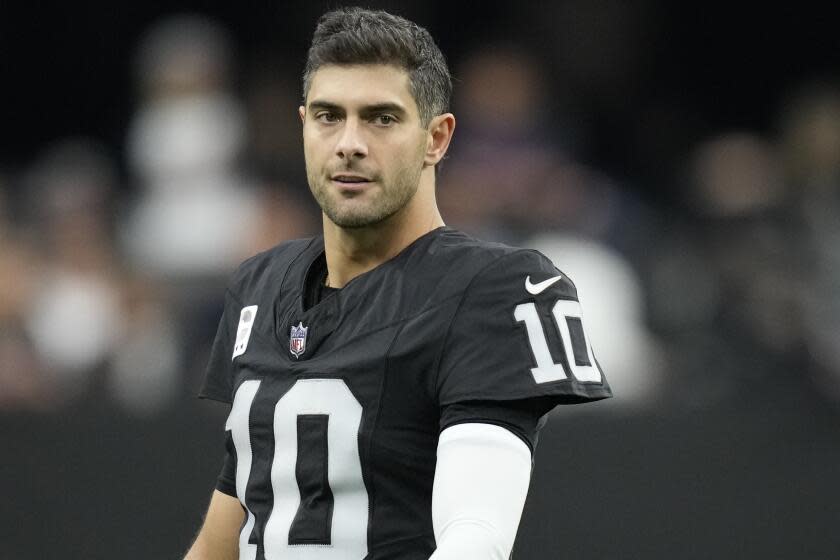 Raiders quarterback Jimmy Garoppolo looks on before a game.