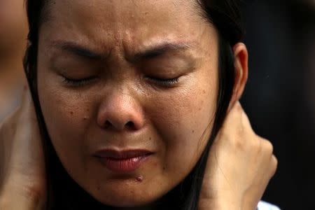 A mourner cries as she pays her respects to Thailand's late King Bhumibol Adulyadej in front of the Grand Palace in Bangkok, Thailand, October 15, 2016. REUTERS/Athit Perawongmetha