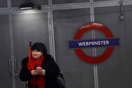 A commuter stands next to a tube sign reading 'Webminster' after Amazon rebranded Westminster tube station as a marketing stunt in central London, Britain January 12, 2017. REUTERS/Stefan Wermuth