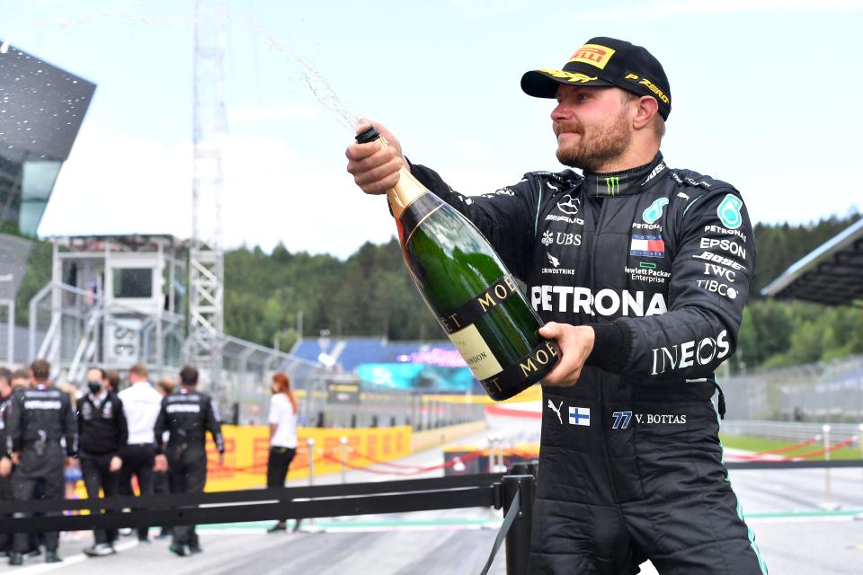 Second placed Mercedes' Finnish driver Valtteri Bottas celebrates with champagne after the Formula One Styrian Grand Prix race on July 12, 2020 in Spielberg, Austria. (Photo by JOE KLAMAR / various sources / AFP) (Photo by JOE KLAMAR/AFP via Getty Images)