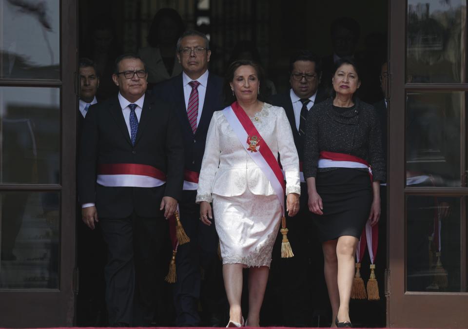 Peruvian President Dina Boluarte, center front, and newly named cabinet members gather for a group photo after their swearing-in ceremony, at the government palace in Lima, Peru, Saturday, Dec. 10, 2022. (AP Photo/Guadalupe Pardo)