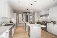 <p>The kitchen features marble countertops, a Sub-Zero stainless steel refrigerator, a wine cooler and a six-burner gas oven.</p>